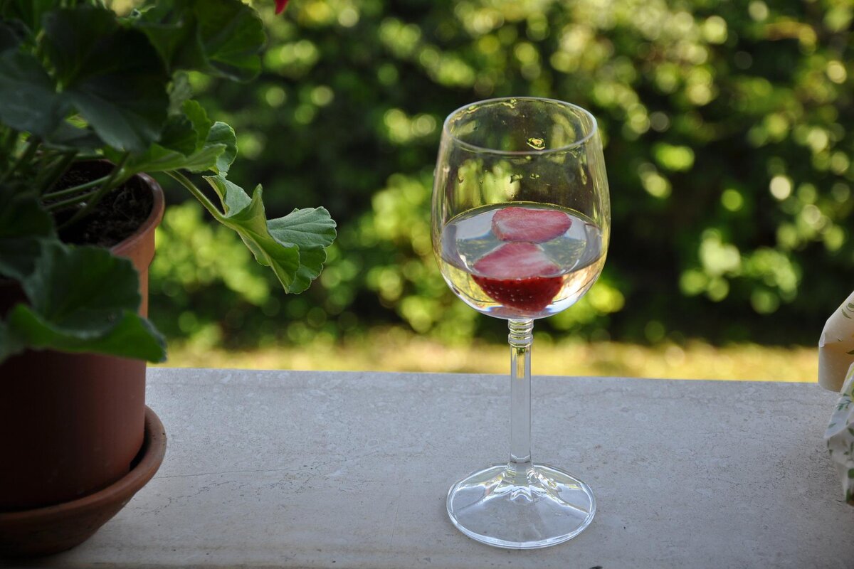 liquid & strawberries in wine glass